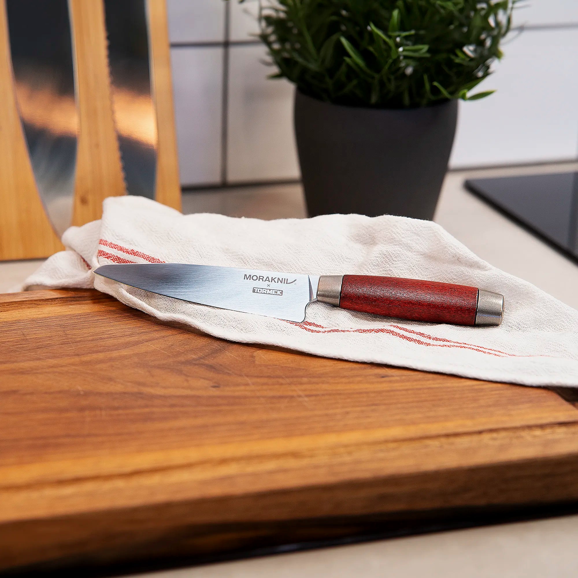 A Morakniv x Tormek 1891 utility knife classic on a kitchen towel in a kitchen